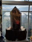 Natural polished Smokey Quartz point on wood stand