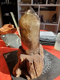 Natural polished Smokey Quartz point on wood stand