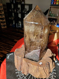 Natural polished Smokey Quartz point on wood stand