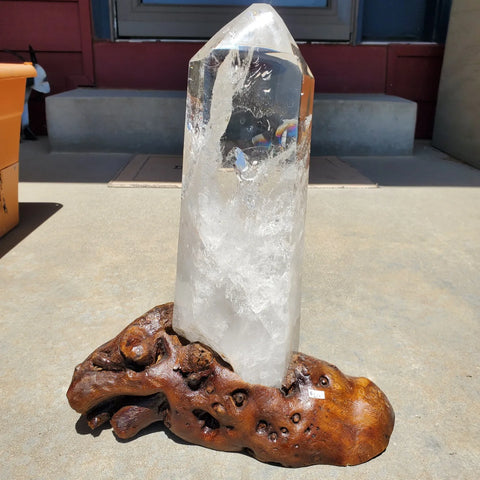 Natural polished Clear Quartz Point on wooden stand