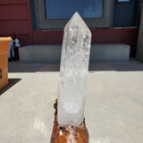 Natural polished Clear Quartz Point on wooden stand