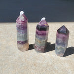 Natural polished Rainbow Fluorite point