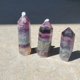 Natural polished Rainbow Fluorite point